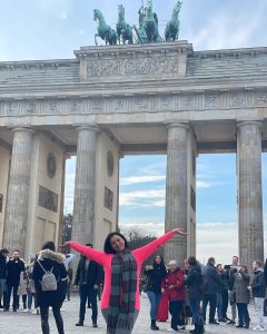 girl standing in brandenburg tur berlin