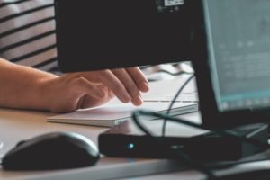 hand typing on computer keyboard